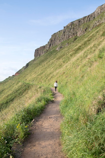 Tourist on Giants Causeway Coastal Footpath, County Antrim, Northern Ireland, UK