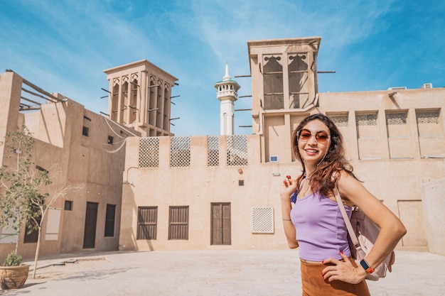 Tourist girl at Al Fahidi historical district and Bur Dubai neighbourhood Travel and historical attractions of United Arab Emirates