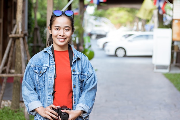 Tourist girl carrying camera