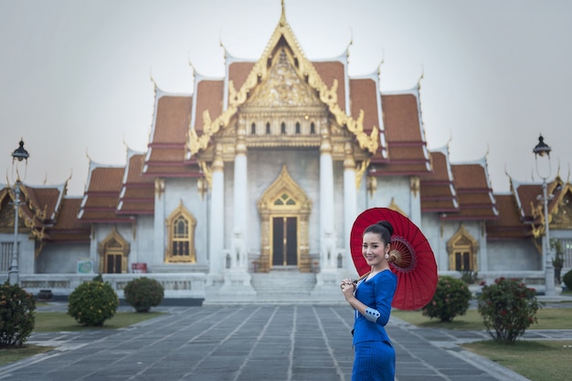 Tourist girl enjoying at Temple of the Emerald Buddha, Bangkok, Thailand.