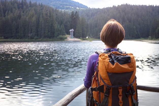 Tourist girl on a mountain lake