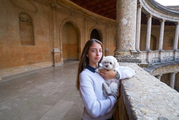 Tourist girl with pet doy in Alhambra Granada