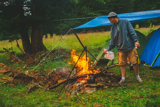 Tourist kindles fire in forest near tents