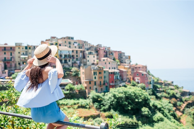 Tourist looking at scenic view of Manarola, Cinque Terre, Liguria, Italy