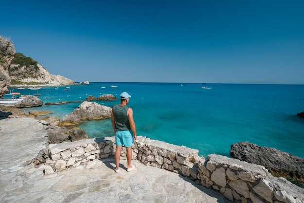 A tourist man enjoy coastline near Agios Nikitas village on Lefkas Ionian Island Greece