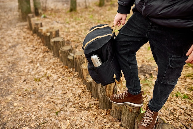 Tourist man looking into his backpack Travel concept Autumn background landscape