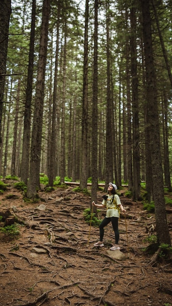 Tourist in middle of Trees with Backpack