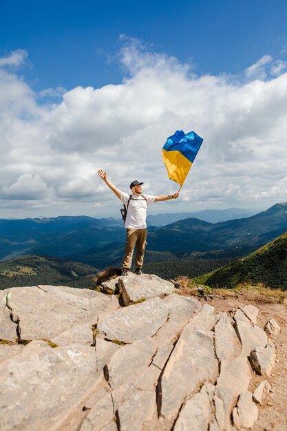 A tourist on the mountains with a ukrainian flag