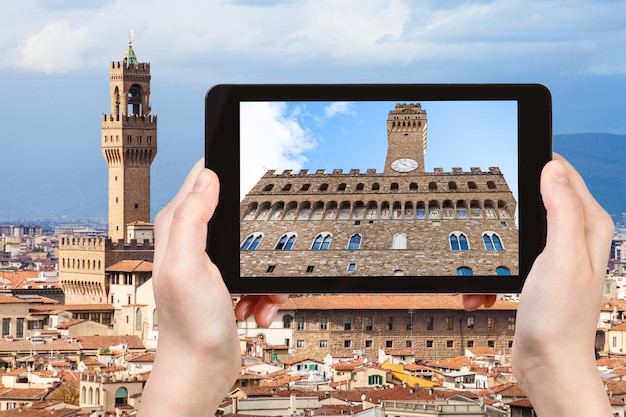 Tourist photographs facade of Palazzo Vecchio