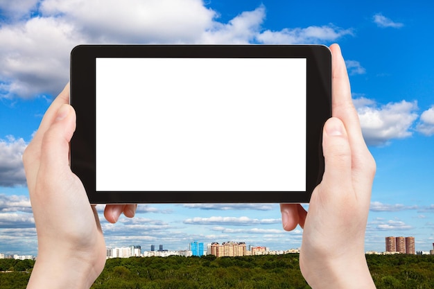 Tourist photographs sky with clouds over town