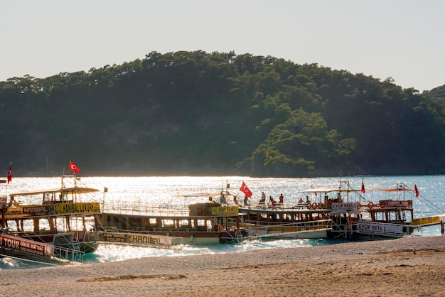 Tourist pleasure boat with people near the beach