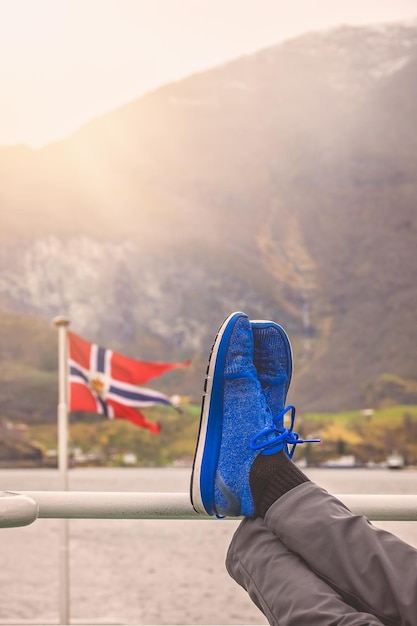 Tourist relaxing during fjord cruise tour in Norway