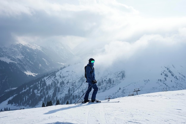 Tourist skiing on peak of snow covered mountain on vacation