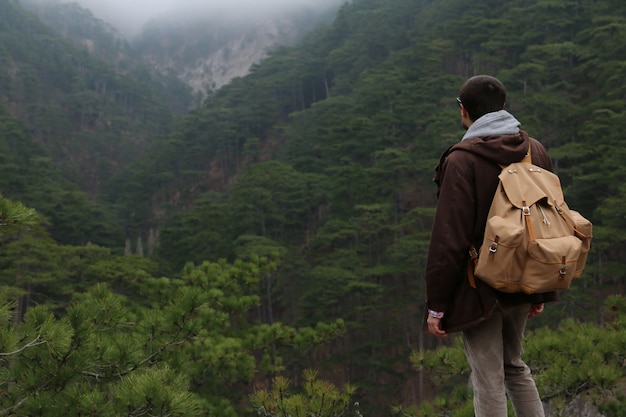 Tourist standing alone in the forest