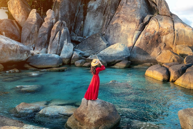 Tourist standing on the rock near Grandfather and grandfather rock Hin Ta and Hin Yai Rocks on the Lamai Beach Koh Samui Thailand