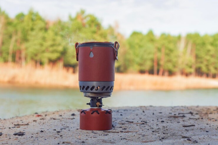 Tourist stove gas for camping and recreation in forest on the background of nature
