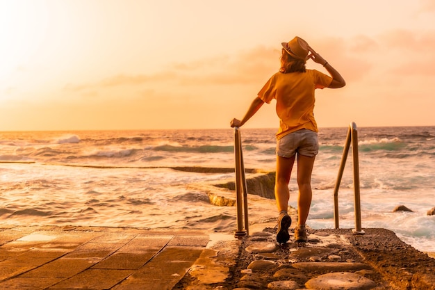 Tourist at sunset in the La Maceta rock pool on the island of El Hierro en la Frontera Canary Islands