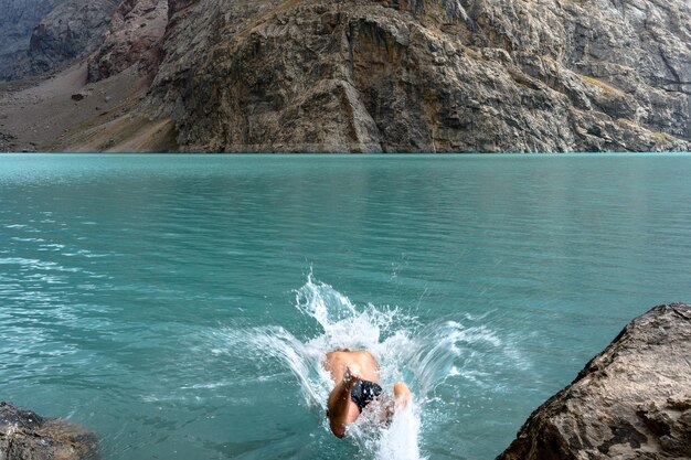 A tourist swims in the mountains of tajikistan fan mountains