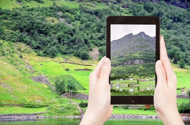 Tourist taking photo of village in Norway