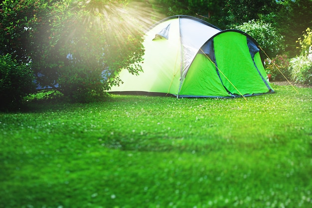 Tourist tent on green meadow