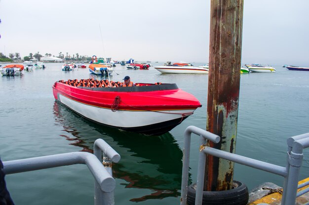 Tourist transport boat anchored in a dock on the seashore