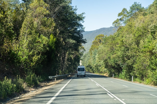 tourist traveling in a caravan exploring nature driving on a raod in the forest Cars Driving on a highway road in australia