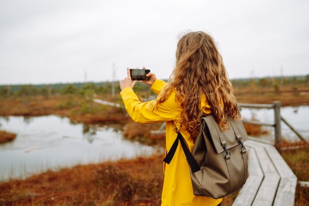 Photo tourist travels in nature photographs landscapes in swamps using mobile phone active lifestyle