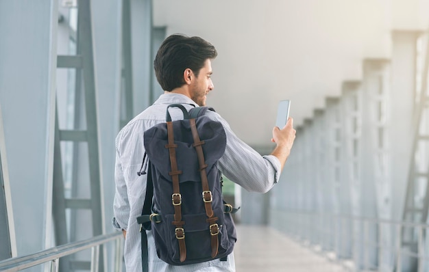 Tourist using his cellphone in airport connecting to roaming