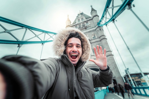 Tourist visiting London England Happy man taking selfie with iconic uk landmark