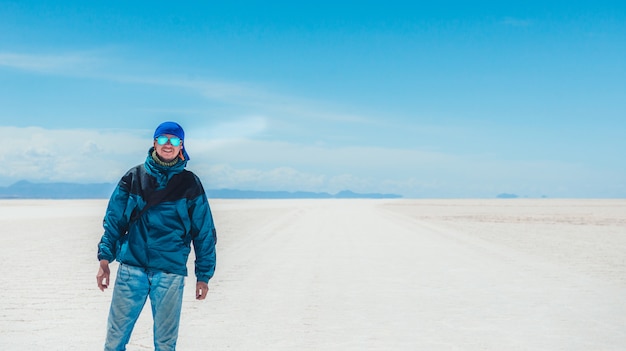 Tourist walking in sunshine Salar de Uyuni