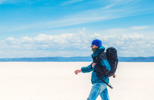 Tourist walking in sunshine Salar de Uyuni