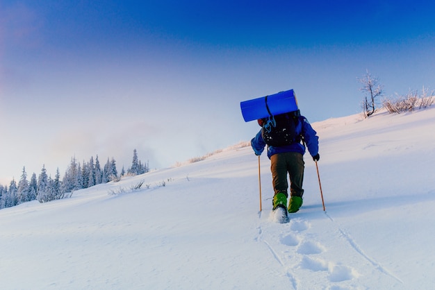 Tourist in winter mountains