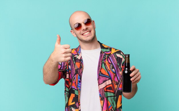 Tourist with beer tourist man feeling proud, carefree, confident and happy, smiling positively with thumbs up