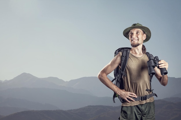 Tourist with binocular in the mountains