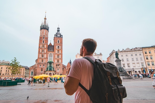 Tourist woman at central krakow market square copy space travel concept