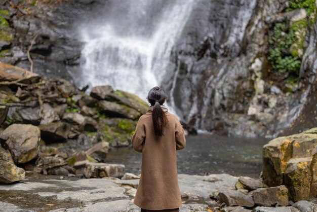 Tourist woman go hiking view the Wufengqi waterfall in Yilan of Taiwan