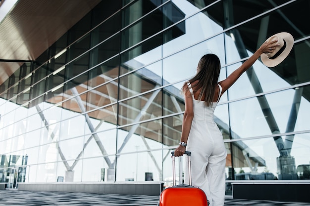 Tourist woman goes with luggage