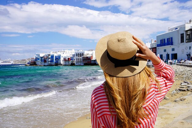 Tourist woman in Little Venice Beach on Mykonos Island Greece Europe