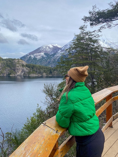 Tourist woman looking at the view of the mountains at circuito chico in barioche argentina