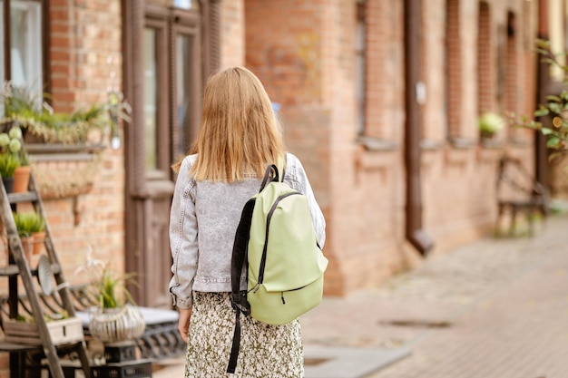 Tourist woman in old town rear view