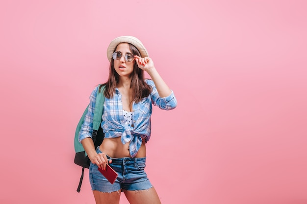 Tourist woman on pink wall