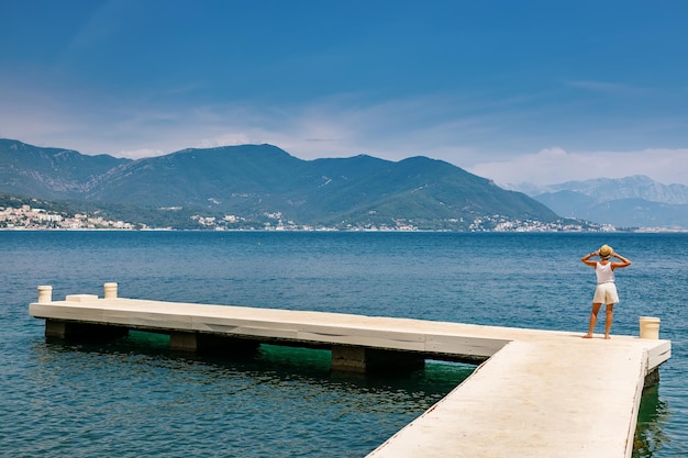 Tourist woman standing on a pier in Montenegro
