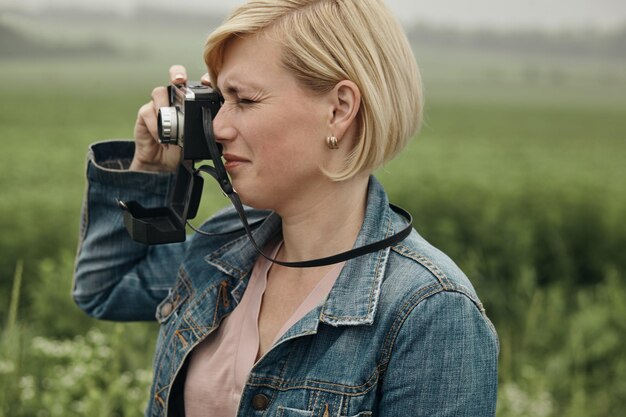 Туристка фотографирует во время путешествия. Девушка фотографирует винтажную ретро-камеру.