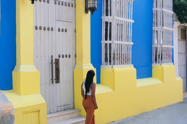 Tourist woman walking through the colorful streets of Cartagena de Indias Colombia