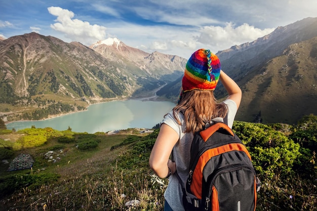 Tourist woman with backpack at the mountains