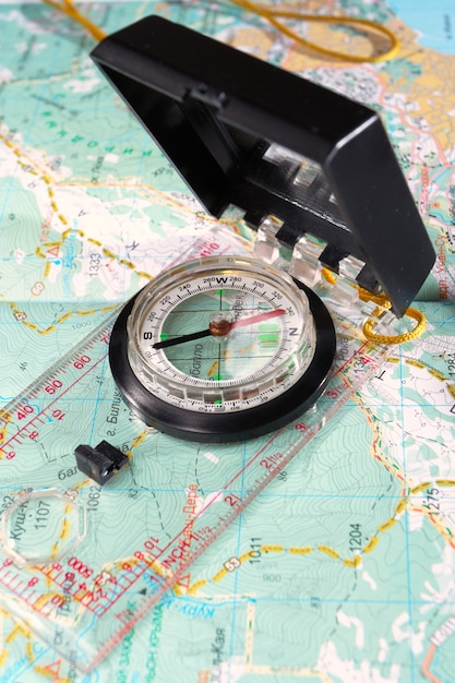 Touristic compass is lying on a map