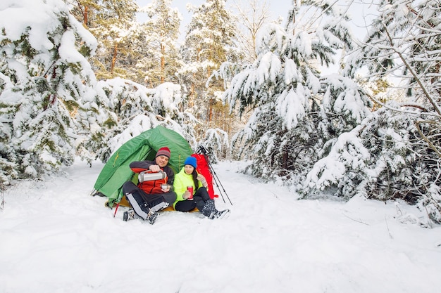 Tourists are walking in the winter forest