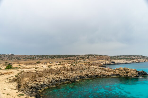 Tourists arrived by car to the blue lagoon for swimming.