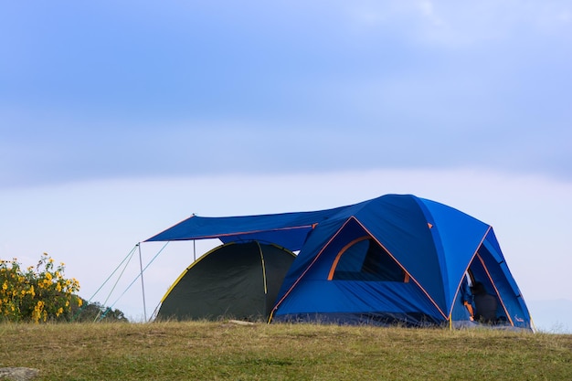 Tourists blue tent on mountain