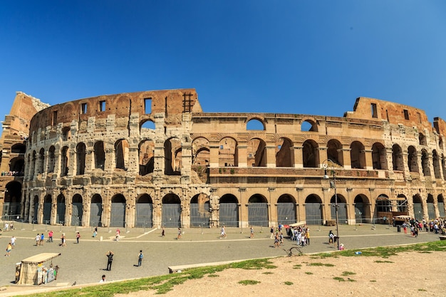 Tourists of a building against blue sky